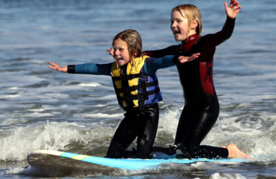 rita Rita Virostko, 4, and Jordan Soros, 6, share surfboard and the revelry of catching a wave at Cowell Beach during low tide on Tuesday. The girls, who have both been surfing since they could walk, were under the watchful eyes of their professional surfing fathers Marcel Soros and Darryl Virostko. (Shmuel Thaler -- Santa Cruz Sentinel)